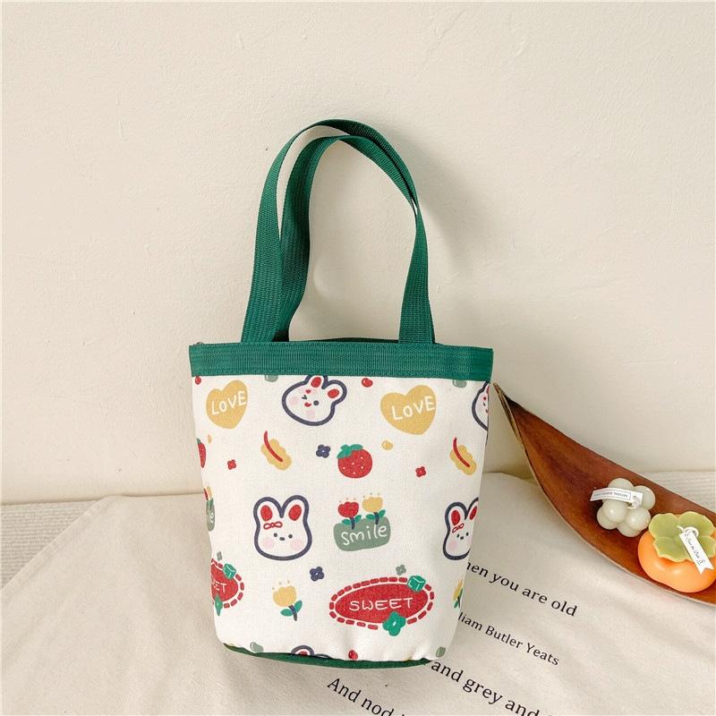 V562-1051124060DBT-202503041320-00 Cartoon Graffiti Bento Bag - Cute Canvas Handbag - Model 1 Green - Image 1