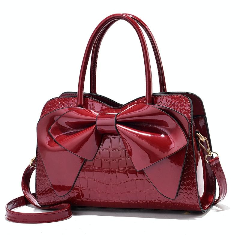 V562-B1040232060DBT-202504251552-00 Leather Ladies Handbag - Bright Bow Design - Red Wine - Image 1