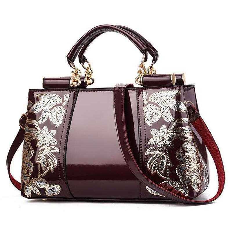 V562-E1088132060DBT-202503041335-00 Shiny Leather Handbag with Single-sided Embroidery - Red Wine - Image 1