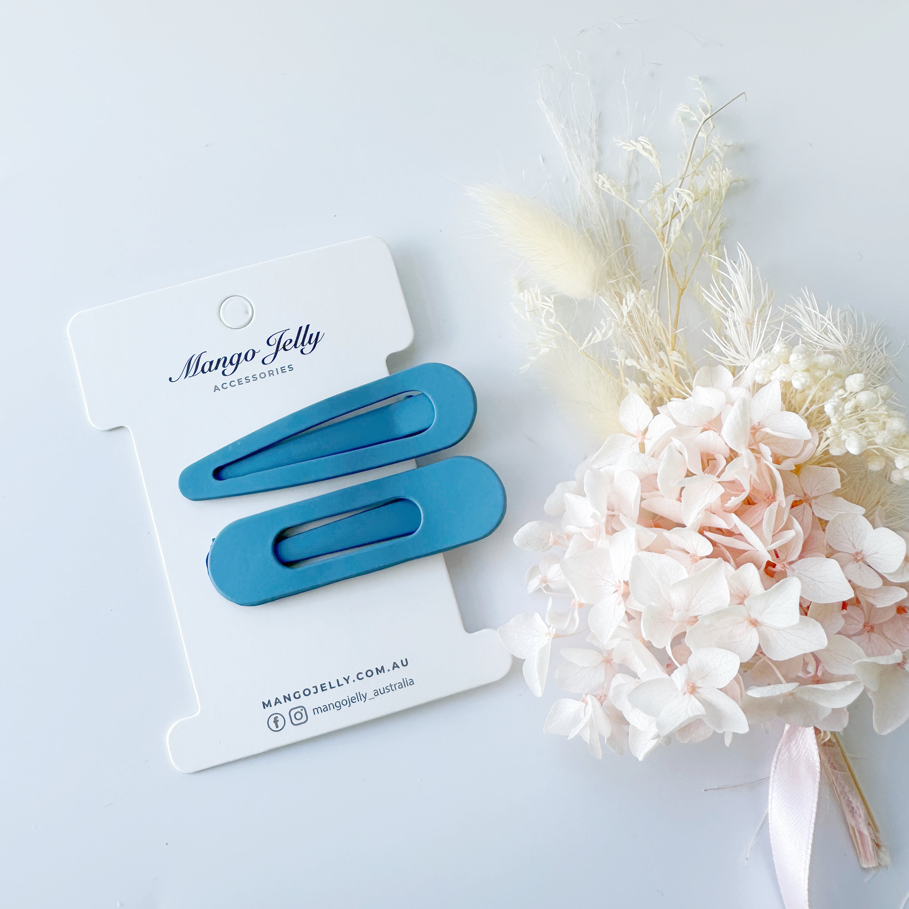 V659-HC-PASTELCOATED-ALI-BLUE-2-L-160755-00 MANGO JELLY Large Pastel Coated Hair Clips -Blue - Twin Pack - Image 1
