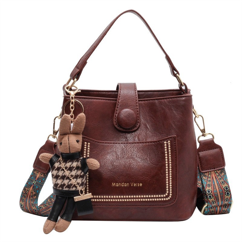 V888-ELOSUNG29855-202506191022-00 Vintage Style PU Leather Bucket Bag with Wide Patterned Strap & Optional Bunny Charm(red brown) - Image 1